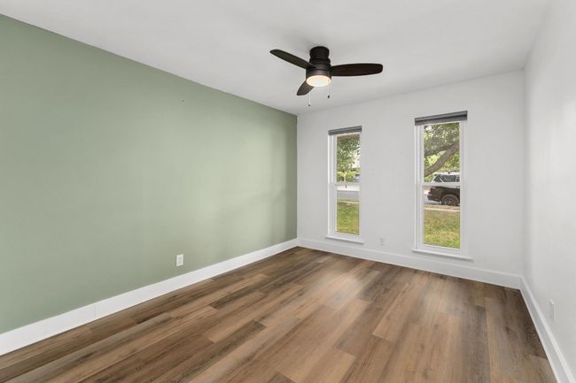Empty room featuring dark wood-style floors and a ceiling fan | Image 18