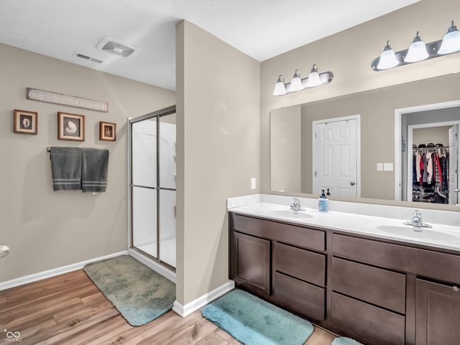 full bathroom featuring visible vents, a shower stall, and a sink | Image 27