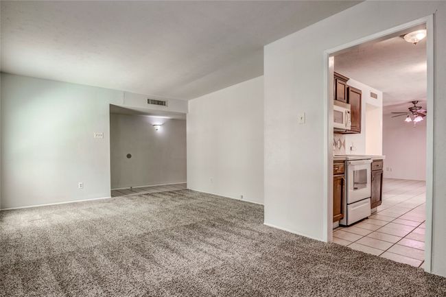 Empty room with light colored carpet and ceiling fan | Image 6