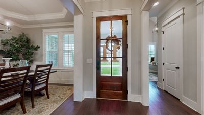 Step into elegance & comfort as you enter this stunning home, where a spacious, light filled foyer welcomes you with rich hardwood floors & custom detailing throughout | Image 3