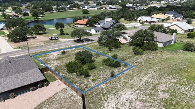 Aerial view of residential area with a large body of water and property parcel outlined | Image 5