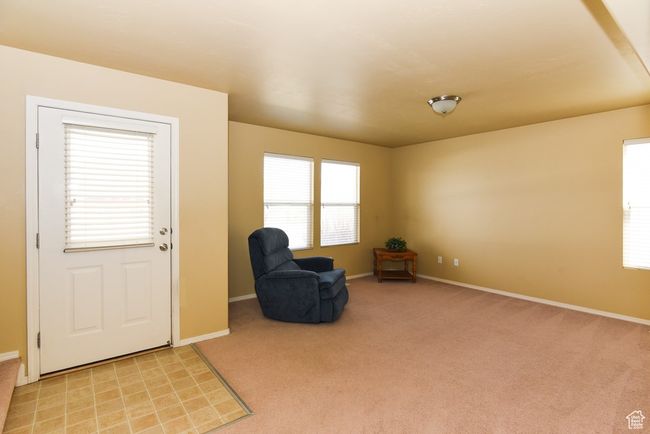 Sitting room with light colored carpet and baseboards | Image 9