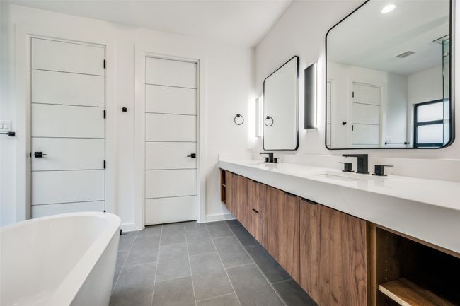 Bathroom featuring a soaking tub, double vanity, and tile patterned floors | Image 24