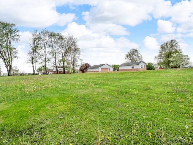 view of yard featuring a detached garage and a rural view | Image 32