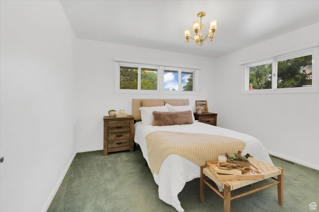 Bedroom featuring a chandelier and carpet floors | Image 14