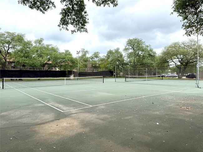 View of tennis court with fence | Image 19