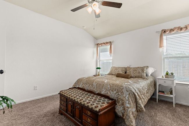 Carpeted bedroom featuring vaulted ceiling and ceiling fan | Image 14