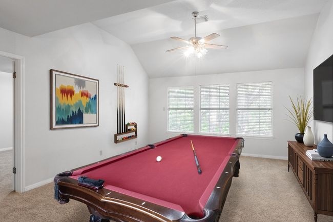 Game room featuring carpet flooring, vaulted ceiling, pool table, ceiling fan, and baseboards | Image 10