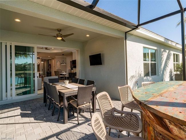 View of patio featuring ceiling fan and glass enclosure | Image 16