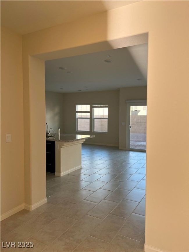 Unfurnished room with light tile patterned floors, baseboards, and a sink | Image 5