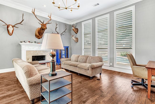 Thick crown molding marks the formal living room as an elegant spot to entertain or for family game nights away from the TV. | Image 17