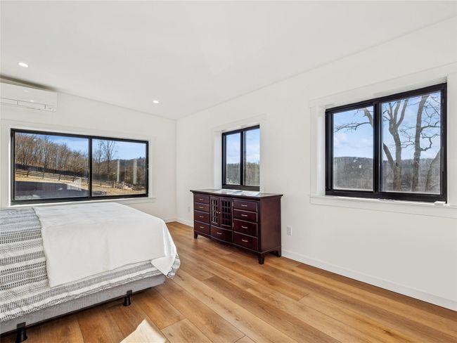 Bedroom featuring luxury vinyl plank flooring for style and durability | Image 13
