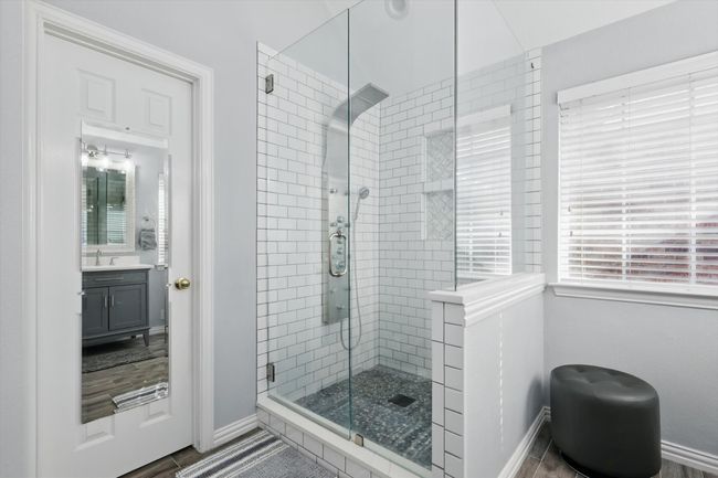 Full bath featuring a stall shower, baseboards, and vanity | Image 18