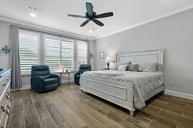Bedroom with crown molding, baseboards, dark wood-style floors, a ceiling fan, and recessed lighting | Image 24