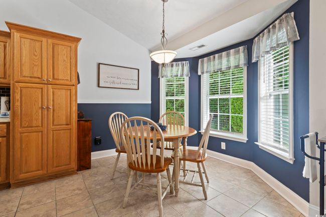 Dining room featuring lofted ceiling and light tile patterned floors | Image 16
