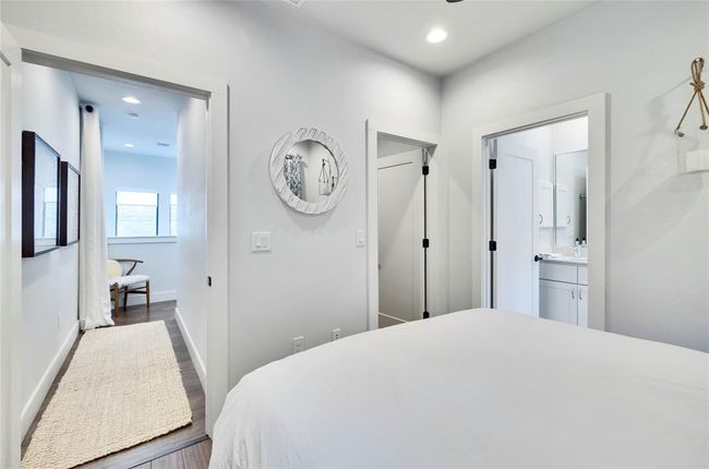Bedroom featuring wood finished floors, recessed lighting, and connected bathroom | Image 14