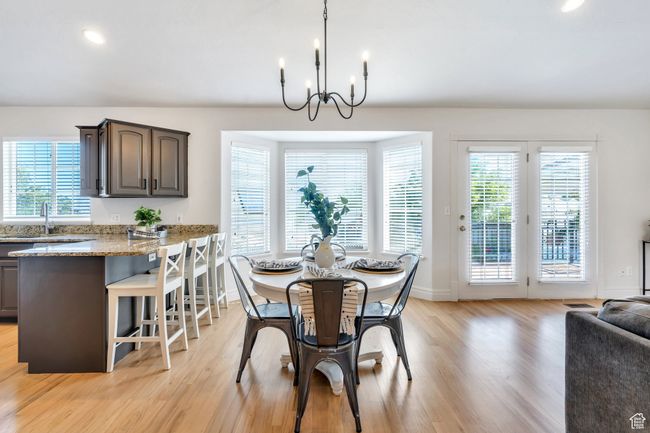 Dining space featuring a chandelier, light wood-style floors, baseboards, and recessed lighting | Image 4