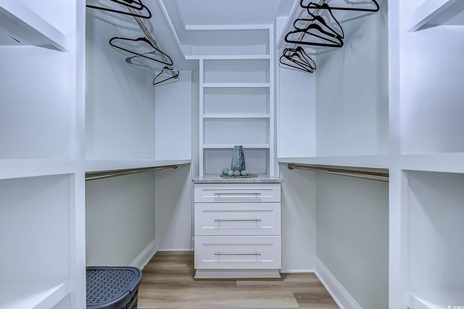 Walk in closet featuring light hardwood / wood-style flooring | Image 20