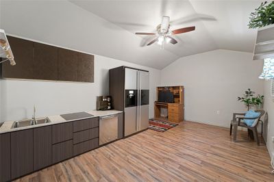 Kitchen featuring sink, light hardwood / wood-style floors, dark brown cabinetry, and ceiling fan | Image 2