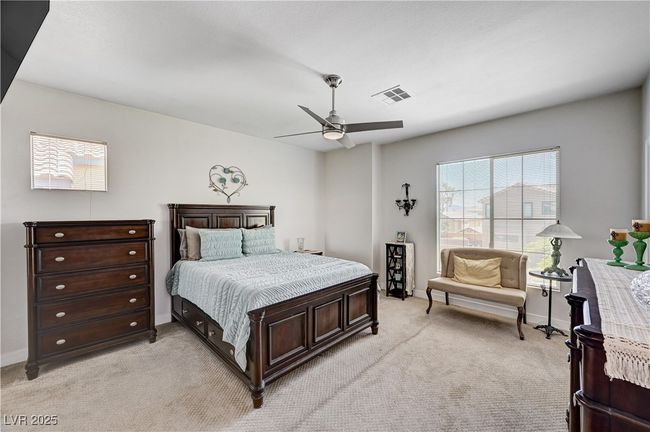 Bedroom featuring light colored carpet and ceiling fan | Image 25