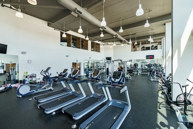 Exercise room featuring a towering ceiling | Image 38
