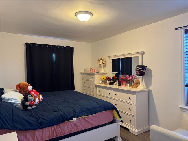 Bedroom featuring dark hardwood / wood-style flooring | Image 4