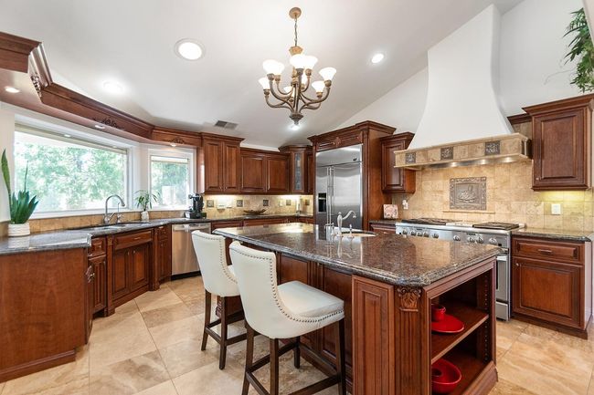 Gorgeous kitchen! center island with sink and breakfast bar. Indirect lighting and 2 tube skylights. | Image 21