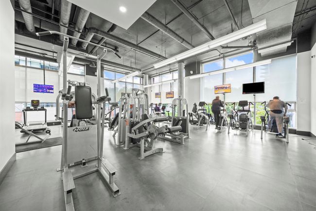 Exercise room with a towering ceiling | Image 26