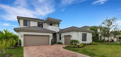 View of front of property featuring a front yard and a garage | Image 1