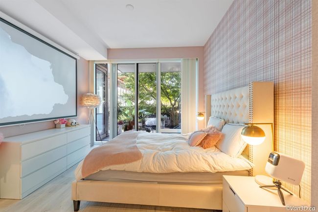 Bedroom featuring wallpapered walls, light wood-style flooring, and access to outside | Image 5