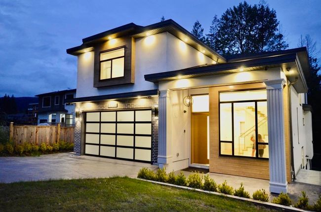 Modern home with a garage, stucco siding, and concrete driveway | Image 35