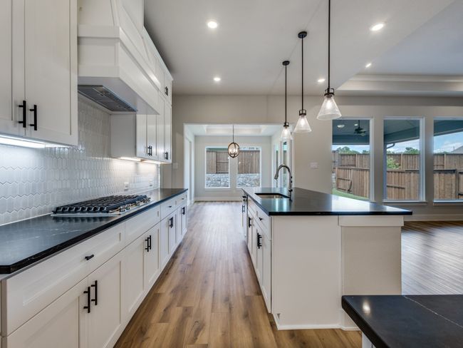 This dream kitchen offers tons of storage and prep space in a classic black & white color palette. | Image 6