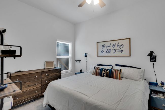Carpeted bedroom with a ceiling fan | Image 27