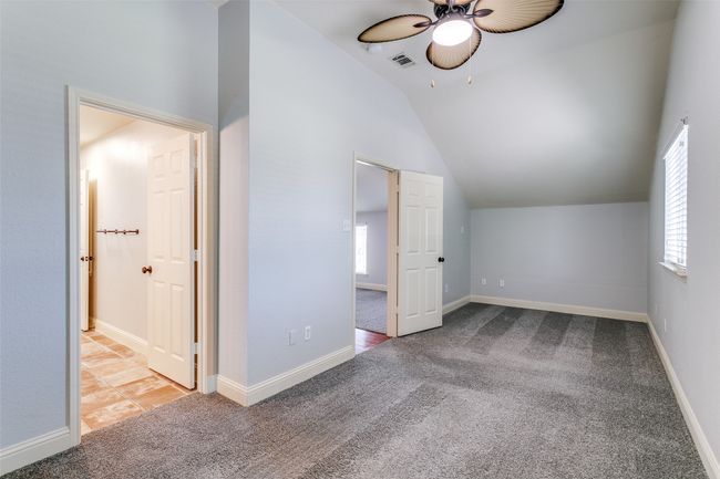 Bonus room featuring ceiling fan, vaulted ceiling, carpet, and plenty of natural light | Image 21