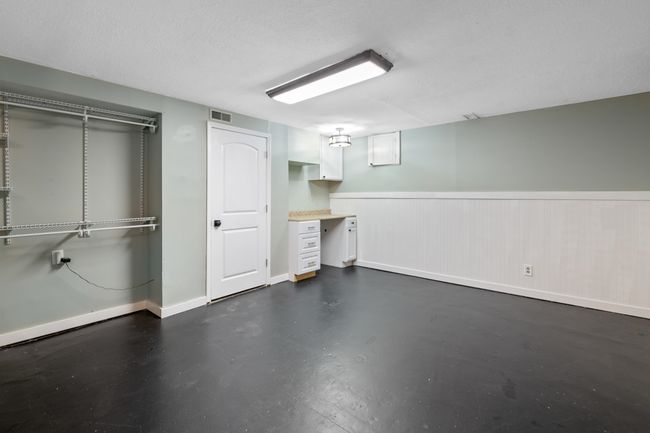 Finished basement featuring wainscoting, baseboards, and a textured ceiling | Image 30