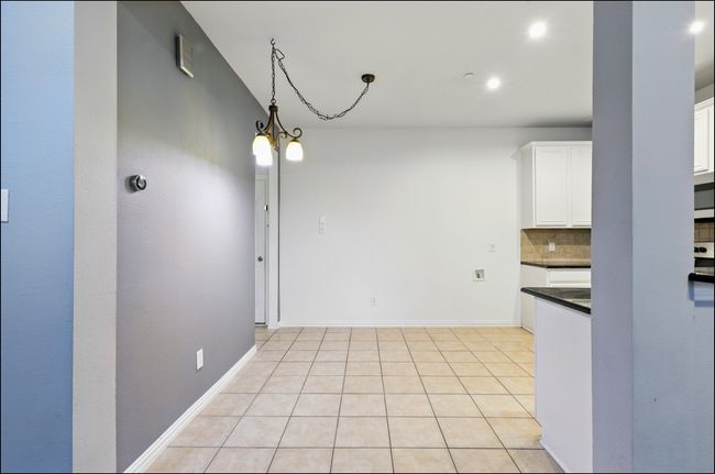 Unfurnished dining area with recessed lighting, baseboards, a chandelier, and light tile patterned floors | Image 9