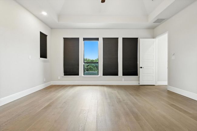 Unfurnished room featuring light wood-style flooring, a raised ceiling, recessed lighting, and ceiling fan | Image 23