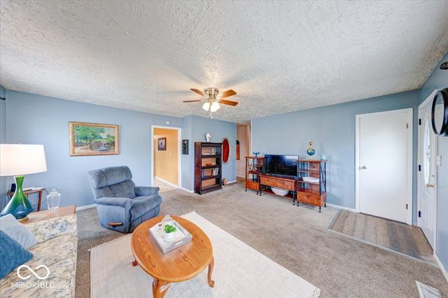 spacious front living room with coat closet | Image 13