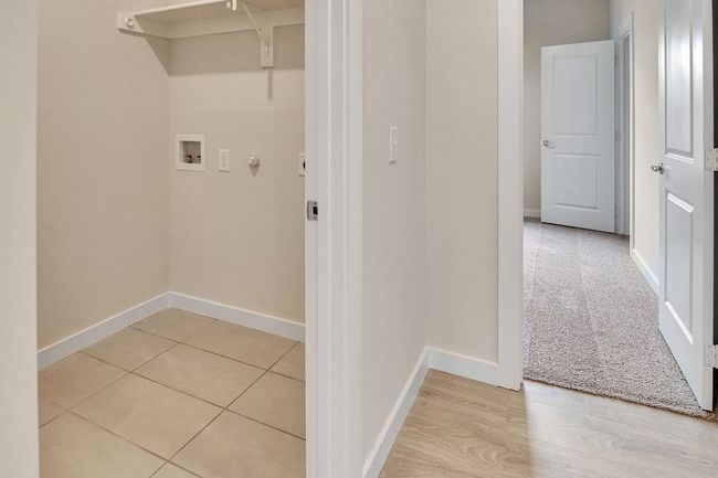Laundry room with hookup for a washing machine and baseboards | Image 16