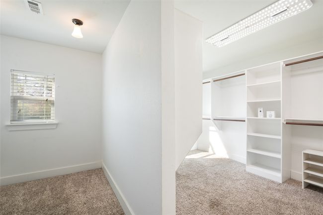 Through the primary bathroom you access the palatial primary close and a convenient flex space | Image 23