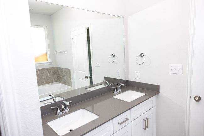 Full bath featuring double vanity and a garden tub | Image 12