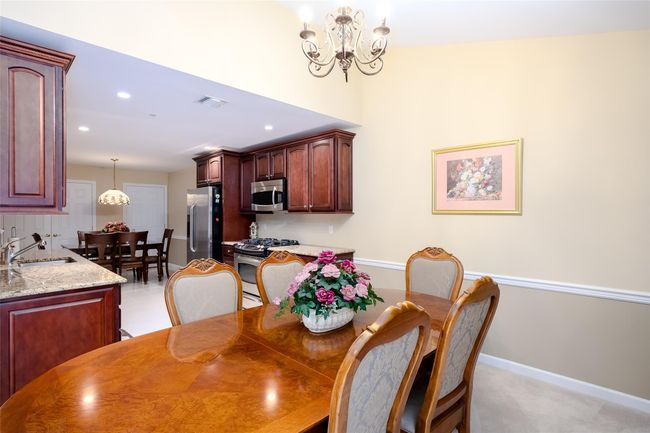 Dining space with a chandelier and recessed lighting | Image 11