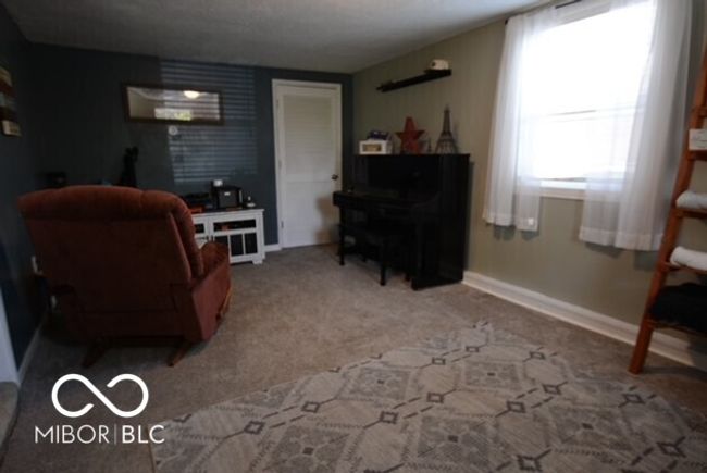living room with carpet floors and baseboards | Image 51