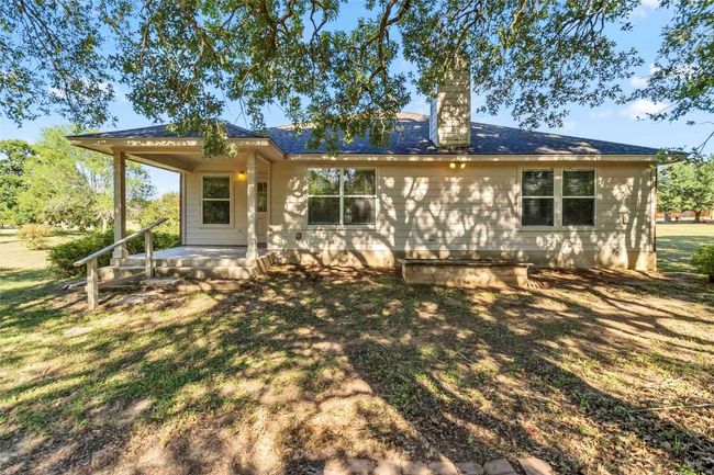 View of front facade featuring covered porch, a chimney, and a front lawn | Image 35