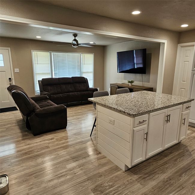 Living room featuring light wood finished floors, recessed lighting, and ceiling fan | Image 9