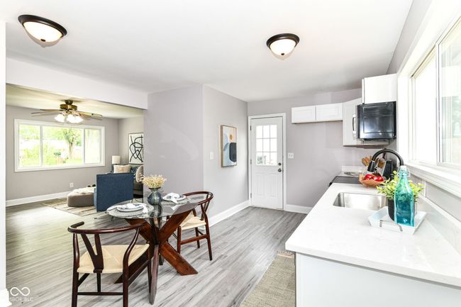 kitchen with a sink, light countertops, and plenty of natural light | Image 10
