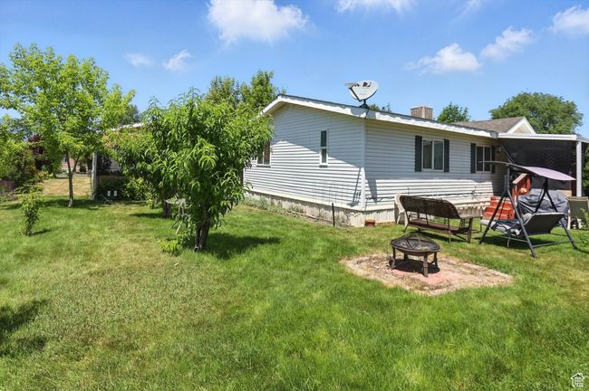 Rear view of property featuring a fire pit and a lawn | Image 21