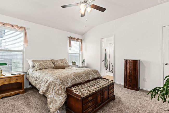 Bedroom with visible vents, carpet flooring, ceiling fan, and lofted ceiling | Image 12