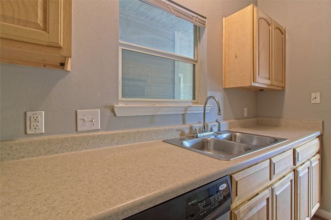 Kitchen with light brown cabinets and light countertops | Image 21