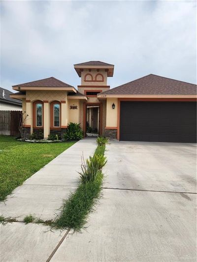 Prairie-style house with a garage and a front yard | Image 1